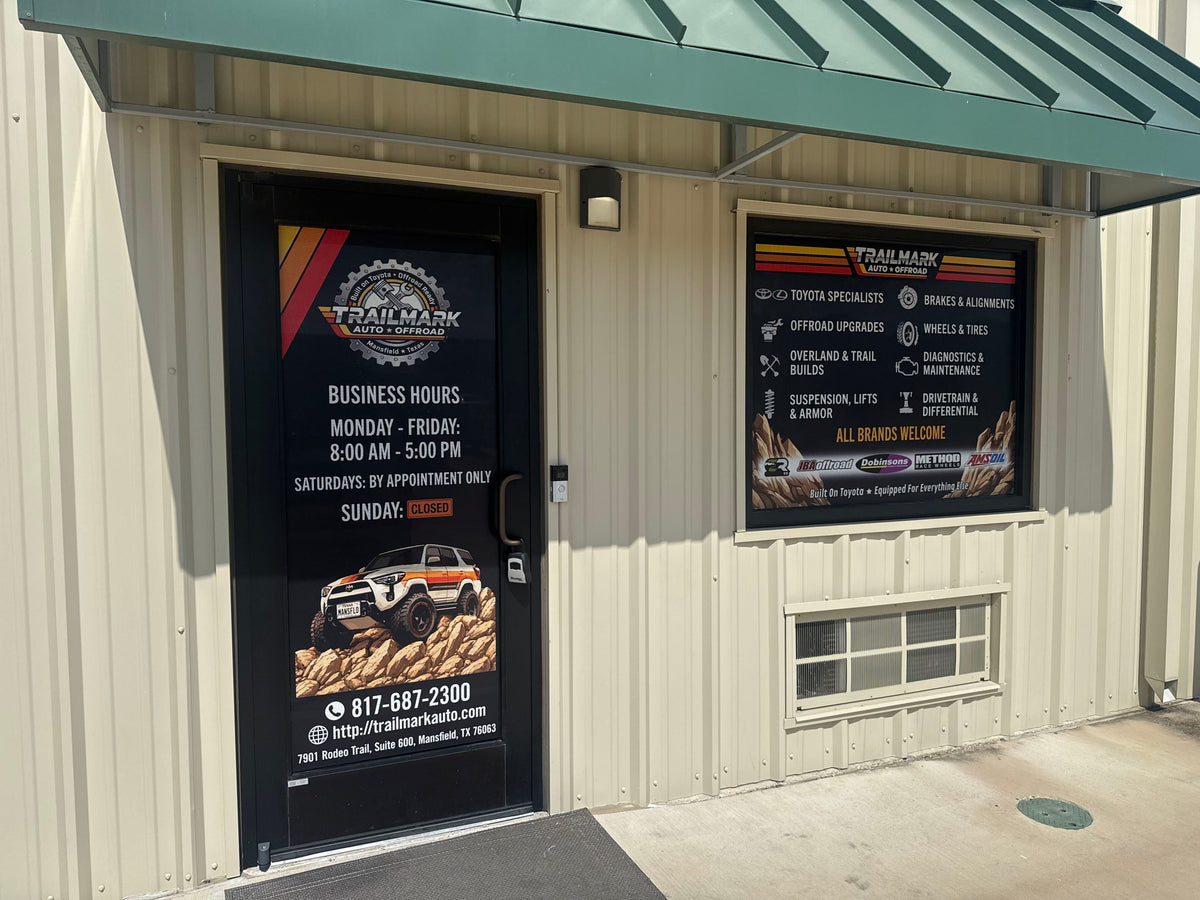 Trailmark Auto & Offroad storefront door with business hours