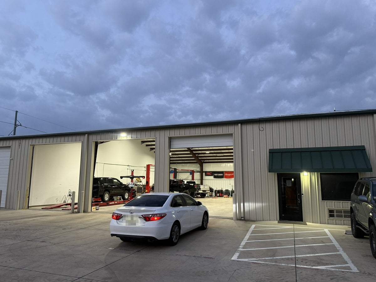 Trailmark Auto & Offroad shop at dusk with the bay lights on