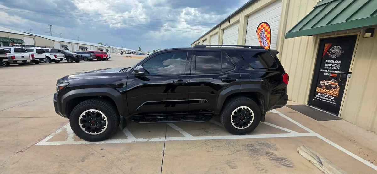 Black Toyota 4Runner TRD Off-Road with Cali Raised armor and rock sliders at Trailmark Auto & Offroad