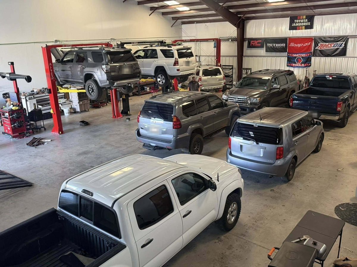 Toyota 4Runners, a Sequoia and a Tacoma in the Trailmark Auto & Offroad shop